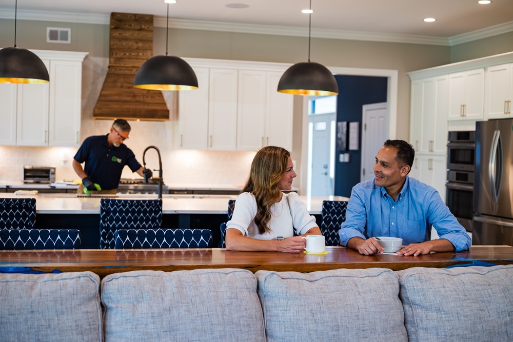 Couple enjoying their new house while Home Valet Pros takes care of the sink