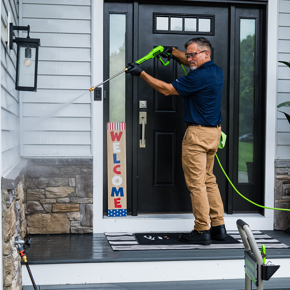 Man Power washing the porch